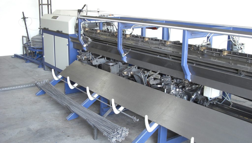 Double-loop bale-tie/quick links straightening and bending machine.